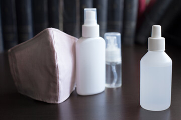 Facemasks on Dark Background with three bottles of sanitizers A respirator protects the wearer from inhaling hazardous atmospheres, including fumes, vapors, gases and particulate matter such as dusts