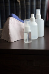 Facemasks on Dark Background with three bottles of sanitizers A respirator protects the wearer from inhaling hazardous atmospheres, including fumes, vapors, gases and particulate matter such as dusts