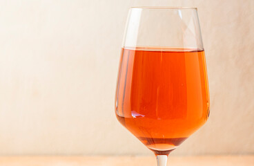 a tall, clear glass of rich orange wine. Alcoholic beverage