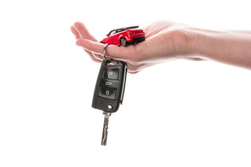 Hand holding keys and red car toy isolated on the white