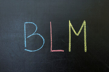 the acronym Black lives matter, BLM on a chalkboard