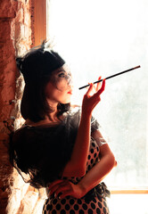 Art deco style in the image of a woman by the window with a mouthpiece and a wuzal
