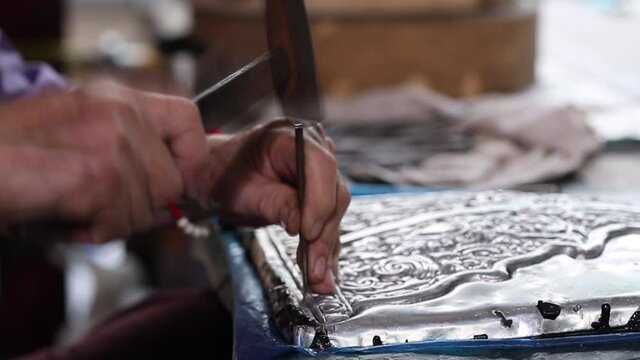 Silverware making. Thai craftman are making silverware. The original of the silver craftsmen on Wua Lai road, Chiang Mai. Thailand.