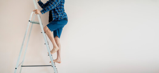 close up workers feet on the ladder climb to the top against the wall with copy space © Mihail