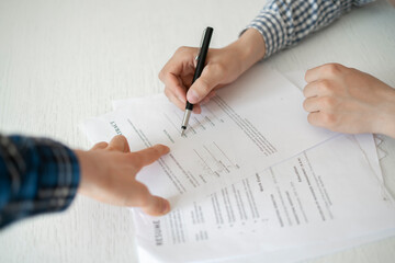 two business partners sitting at the table and sign the agreement contract document