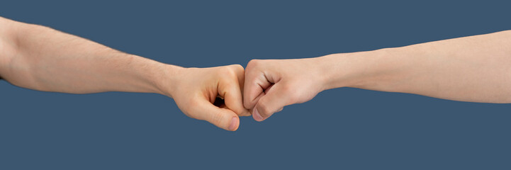 two hands fists punch each other as the symbol of strong partnership and good relationship