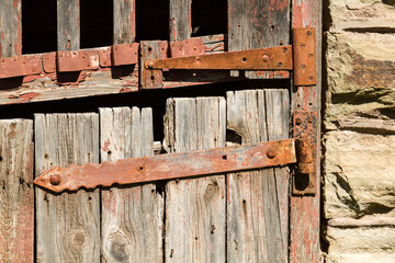 Close up of weather beaten door of stable on farm
