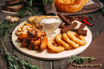 Side view on beer snacks set on the board
