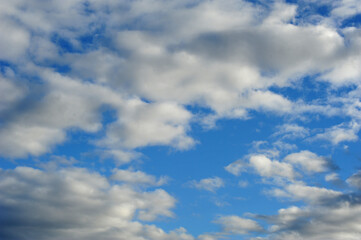 Blue summer sky with white clouds.  Horizontal photo.