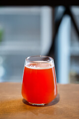 Tasty sour ale craft beer in a glass on wooden surface