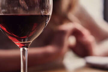 Large red wine in a glass transparent glass on a high leg. Background without vocal. Blur. High quality photo