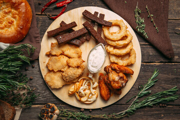 Top view on beer snacks set on the board