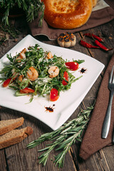 Closeup on arugula shrimps and tomatoes salad