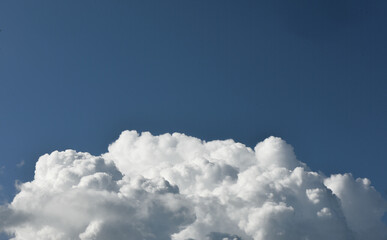 Naklejka na ściany i meble clouds swirl in the blue sky