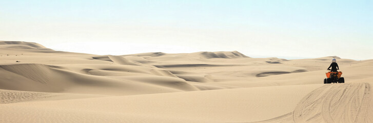 Quad driving people - one happy biker in sand desert dunes, Africa, Namibia, Namib, Walvis Bay, Swakopmund.
