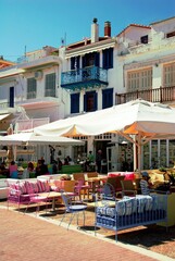 Fototapeta na wymiar Greece, Skiathos island, street with modern coffee-bar restaurants in Skiathos town, May 6 2012.