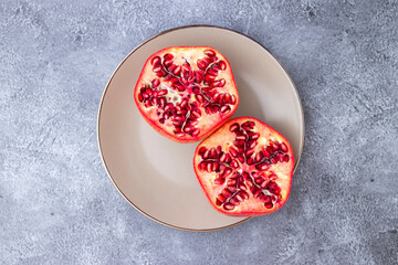 Obraz na płótnie Canvas Pomegranate fruit cut in half and served on a plate