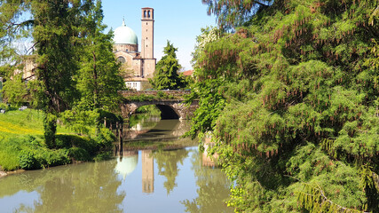 Basilica del Carmine in Padova, Italy. Church near the bridge with a reflection in the river.