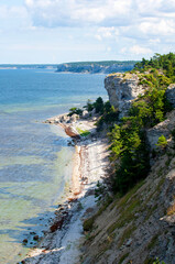 Sand beach below limestone cliff at island of Gotland, Sweden