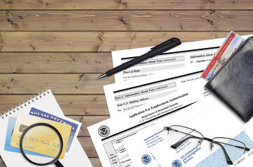 USCIS form I-765 Application for employment authorization lies on flat lay office table and ready...