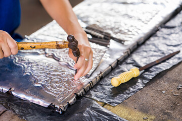 Silverware making. Thai craftman are making silverware. The original of the silver craftsmen at Wua Lai road, Chiang Mai. Thailand.