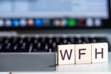 WFH letters on a laptop keyboard to denote Working From Home. An increasingly common change in business practice in response to the global pandemic.