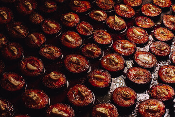Plums and garlic in the oven. Delicious dried plums. Prepare dried plums in the oven in the kitchen.
