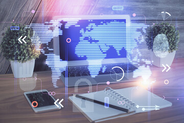 Multi exposure of table with computer and world map hologram. International data network concept.