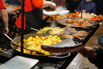 Food booth selling traditional Polish street food at a Christmas Market stall in Krakow, Poland. Traditional Polish street food in Cracow.             