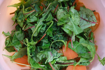  green salad in a bowl top view. close-up. amid a pink plate - 355475919