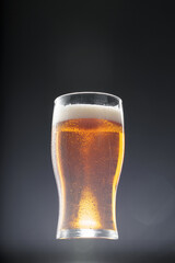 Glass of beer on black background, copy space