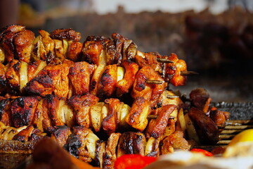 Food at the festival of street food in Krakow/Cracow, Poland. Grilled meat and vegetables. Shashlik or shashlyk is a dish of skewered and grilled cubes of meat.