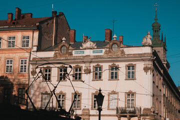 Lviv city architecture. Traction cables. Clear blue sky, golden hour. 
