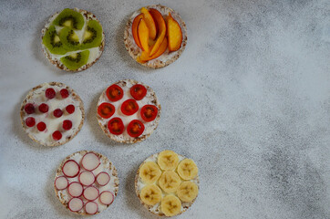 Vegetarian food cereals with curd cheese, cherry tomato slices, radish, kiwi, nectarine, banana and...