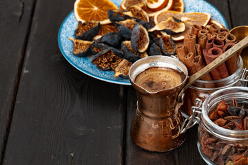 Copper turk with coffee and dried fruit pieces on table