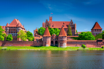 Fototapeta premium Malbork castle by the Nogat river at summer, Poland