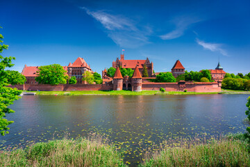 Naklejka na ściany i meble Malbork castle by the Nogat river at summer, Poland