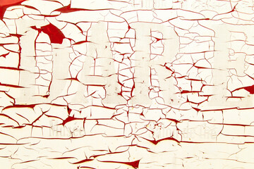 Dry and cracked old paint on the wall.
