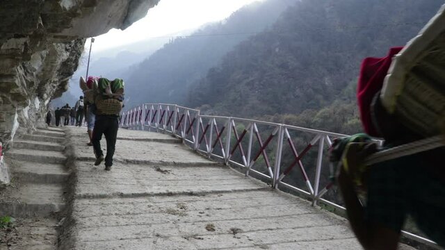 pilgrim getting carried in a basket on the route of kedarnath 