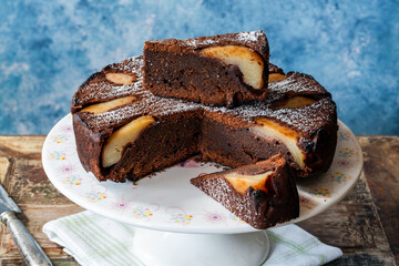 chocolate cake with pears dusted with icing sugar