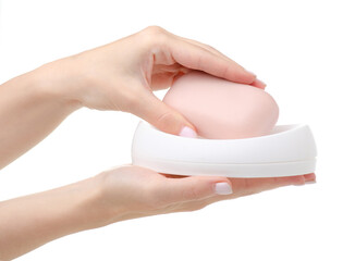 Pink soap in white a soap dish in hand on white background isolation