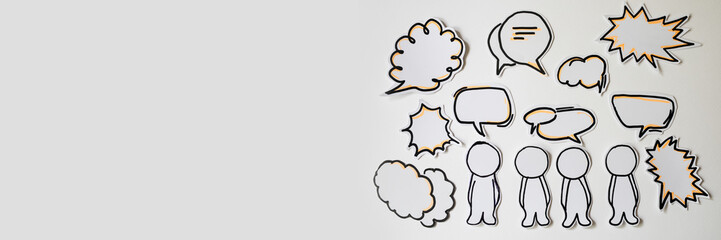Paper figures with speech bubbles on the white