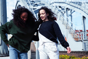 young cute teenage girls together in industrial zone happy smiling having fun, big city lifestyle...