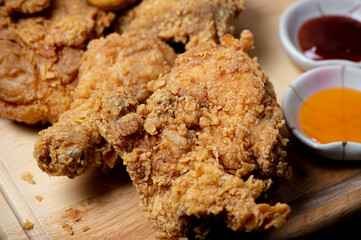 fried chicken and nuggets meal with ketchup and chili sauce  on the wood plate, top view