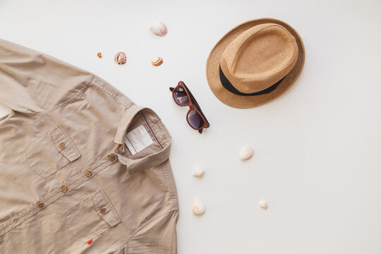 Fashionable concept, mens shirt and sunglasses isolated on white background. Flat lay, summer style concept.