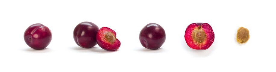 Obraz premium A set of sliced purple plums. Close up. Isolated on a white background