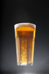 Glass of beer on black background, copy space