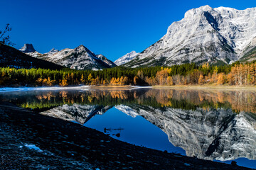 Rockies reflected in Wedge Pond an a crips autumn day. Spray Valley Provincial Park.