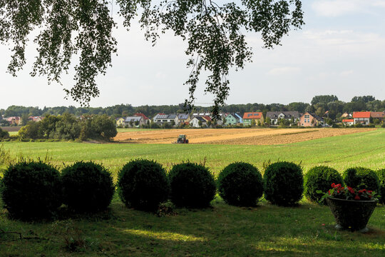 View of a cultivation field among bushes near to the city of Fürstenfeldbruck.