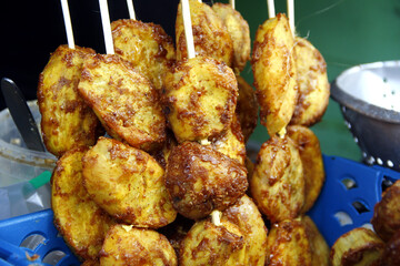 Filipino snack food called Kamote Cue or deep fried sweet potato with brown sugar in barbecue sticks